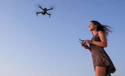 woman flying a drone. You can fly drones in any area that is not a no drone zone in alberta.