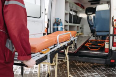 Loading an ambulance. Costs of ambulance ems services in alberta canada.