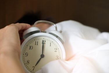 clock on bed with daylight in window. Alberta mountain time zone time changes.