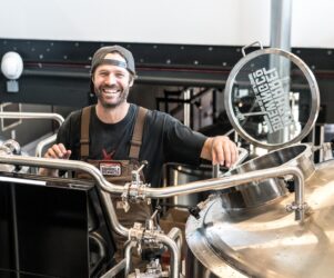 brewery man smiling. you can not make homemade moonshine in alberta canada. You must have a license.