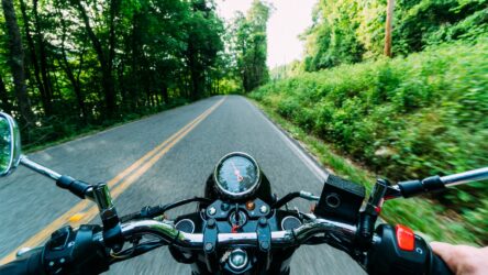 person riding motorcycle on road. you need a class 6 motorcycle license to drive a 3 wheel can-am spider bike in Alberta, Canada.