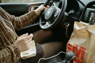 Eating while driving a car is not illegal in Alberta.