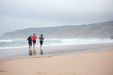 people running at the beach. Women can not be shirtless in public according to canada’s nudity laws.