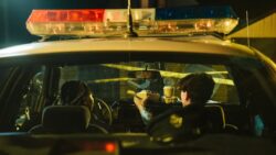 police officers inside a police car. It is illegal to drive with an expired driver’s licence in alberta.