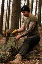 man chopping wood with an axe in a forest. Let’s explain permits and rules and answering the question of “can you cut firewood on crown land in alberta?”