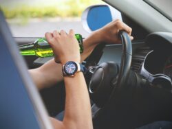 person driving and drinking. You can not legally have opened alcohol in the vehicle in alberta canada.