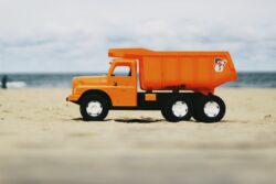 photo of orange dump truck toy. The step by step guide to how to get a class 3 license in alberta, canada.