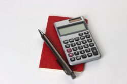 black and silver calculator beside black pen. We discuss the top tax rate in alberta canada.