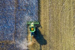aerial shot of green milling tractor. Harvesting times that are typical for crops in Alberta canada.