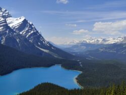a lake surrounded by mountains in alberta. What is the highest point in alberta canada?